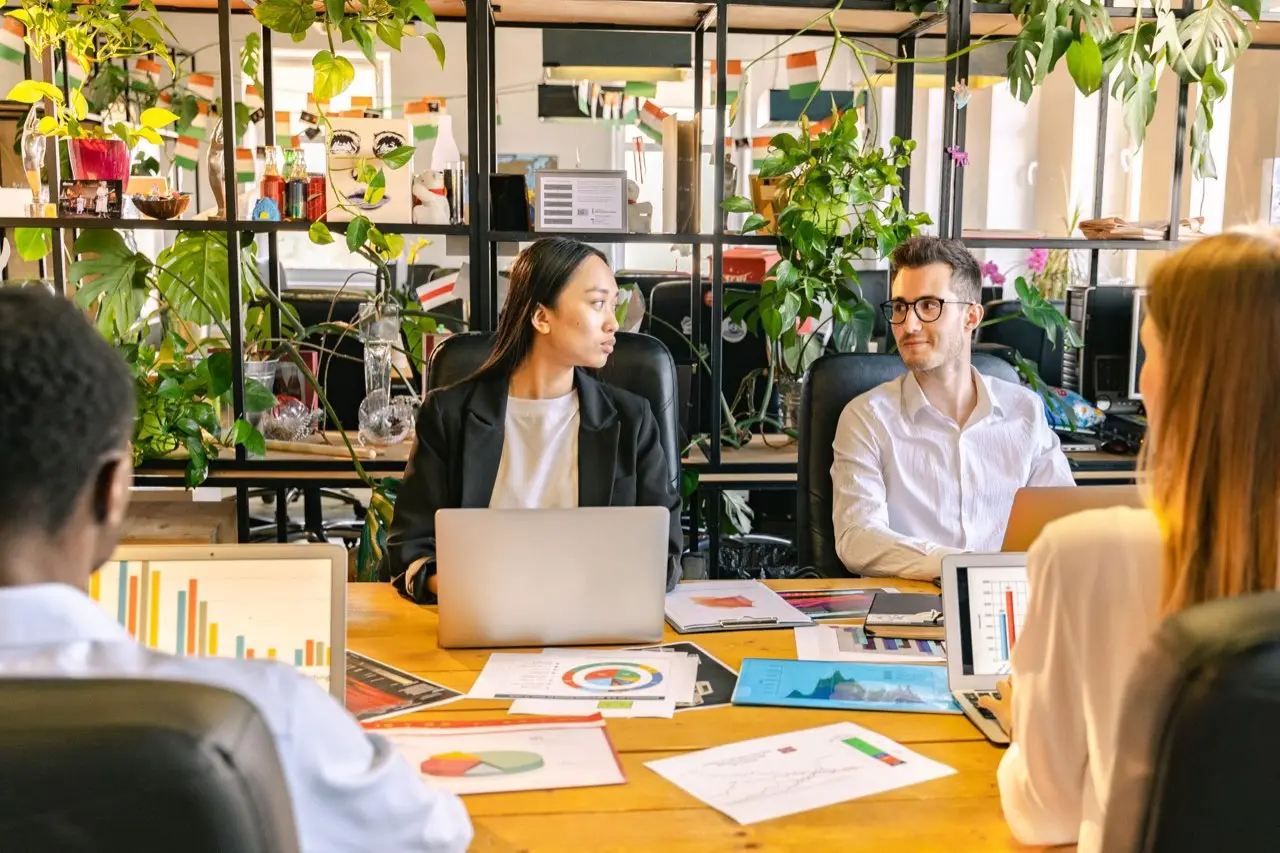 A diverse group of independent workers talking around a community table